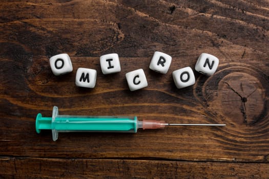 Corona virus Covid-19 vaccine text on wooden background