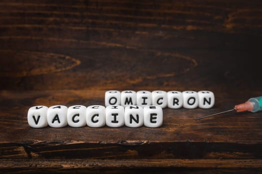 Corona virus Covid-19 vaccine text on wooden background