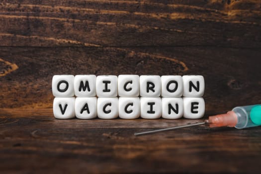 Corona virus Covid-19 vaccine text on wooden background