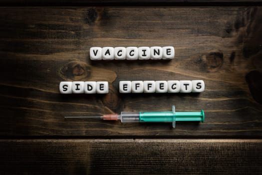 Corona virus Covid-19 vaccine text on wooden background