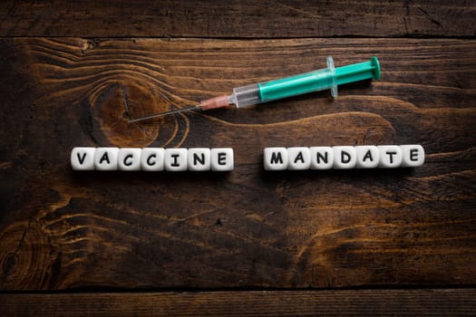 Corona virus Covid-19 vaccine text on wooden background