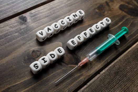 Corona virus Covid-19 vaccine text on wooden background