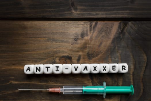 Corona virus Covid-19 vaccine text on wooden background