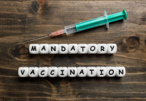 Corona virus Covid-19 vaccine text on wooden background