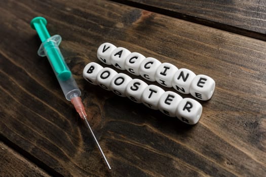 Corona virus Covid-19 vaccine text on wooden background
