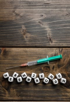 Corona virus Covid-19 vaccine text in German on wooden background