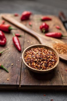 Variety of fresh and dried chili peppers on rustic background