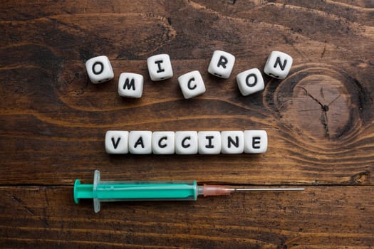 Corona virus Covid-19 vaccine text on wooden background