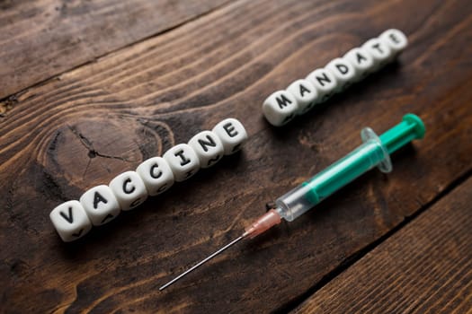 Corona virus Covid-19 vaccine text on wooden background