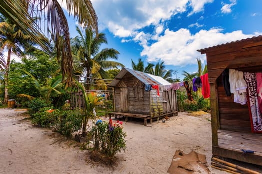 Laundry day in small village in Masoala, freshly washed laundry hanging on a string next to a shack. Maroantsetra, Madagascar