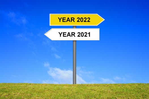 Signpost yellow and white showing year 2021 and year 2022