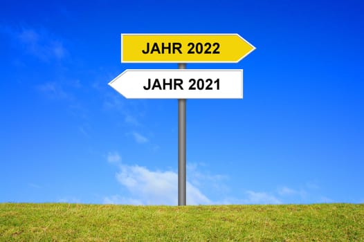 Signpost yellow and white showing year 2021 and year 2022 in german language
