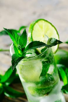 Mojito cocktail on wooden table closeup