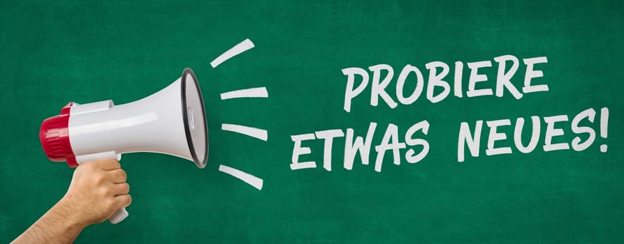 A man holding a megaphone - Try new things in german - Probiere etwas Neues