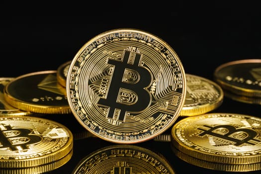 Bitcoin cryptocurrency digital bit coin BTC currency concept ,Golden coins with bitcoin symbol on a black background