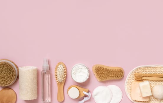 Organic natural cosmetics and zero waste reusable accessories for skin and hair care on pink flat lay with copy space. Top view of eco friendly beauty products for bath, massage or spa salon