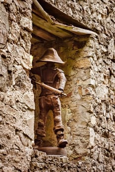 Metal statue of a fireman in a window opening