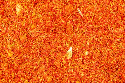 Top view, detail of bright orange red dried saffron (Crocus sativus) flowers spice displayed on food market, Kyrenia, Northern Cyprus