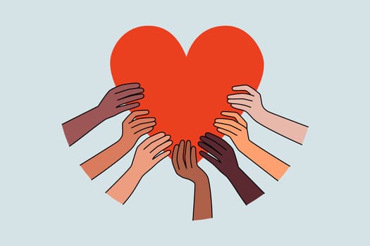 Diverse hands hold huge heart share love