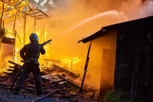 Firefighters extinguish a fire in a farm building. High quality photo