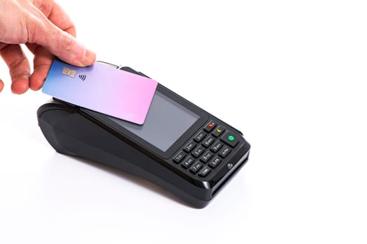 Attached plastic card to the payment terminal with a man's hand on a white isolated background, copy space. High quality photo