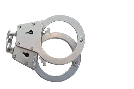 Metal handcuffs on a white isolated background, copy space. High quality photo