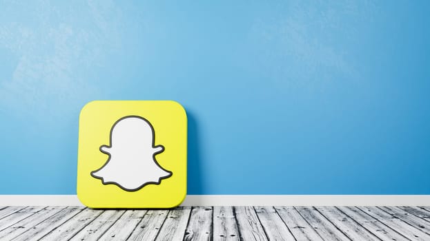 Snapchat Logo 3D Symbol Shape on Wooden Floor Against Blue Wall with Copy Space 3D Render Illustration