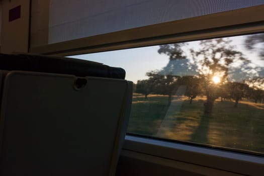 Train crossing dehesa forest of Extremadura, Spain. View from Interior