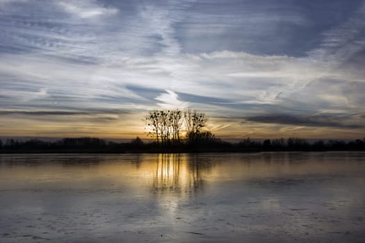 Sunset reflection in a frozen lake, January evening, Stankow, Poland