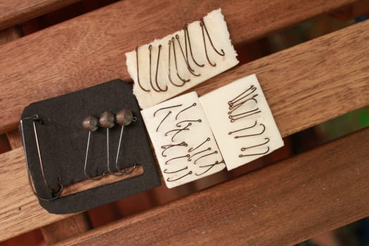 sets of different sizes of fishing hooks on the table close-up