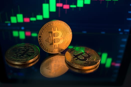 Bitcoin and cryptocurrency investing concept. Bitcoin cryptocurrency coins. Trading on the cryptocurrency exchange. Trends in bitcoin exchange rates. Rise and fall charts of bitcoin