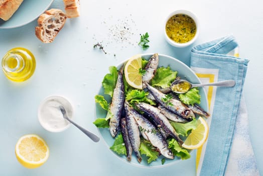 Grilled sardines with lemon and herbs close up. Healthy vegetarian fish meal