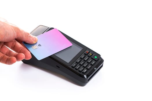 Attached plastic card to the payment terminal with a man's hand on a white isolated background, copy space. High quality photo