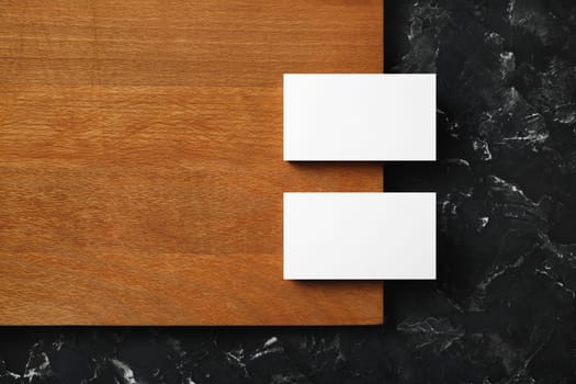 Blank business cards on wooden board background. Mockup for ID. Template for graphic designers portfolios. Flat lay.