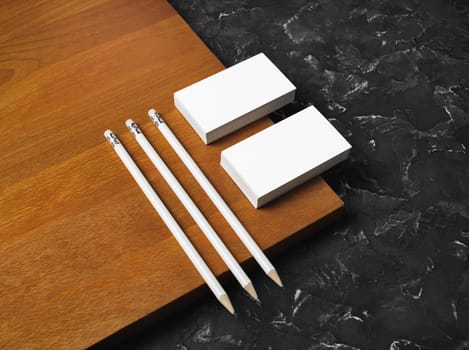 Blank stationery set on wooden board background. Blank business cards and pencils. Corporate identity template. Responsive design mockup.
