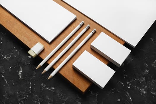 Blank corporate stationery template and wooden board. Mockup for design presentations and portfolios.