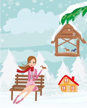 Girl feeds the birds in winter