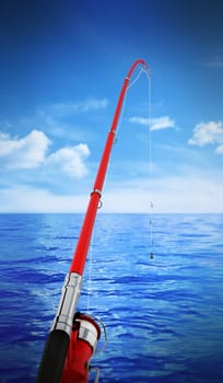 Fishing rod against sea and clear sky background. 3D illustration.