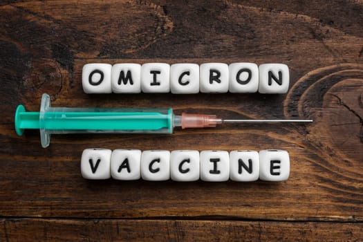 Corona virus Covid-19 vaccine text on wooden background