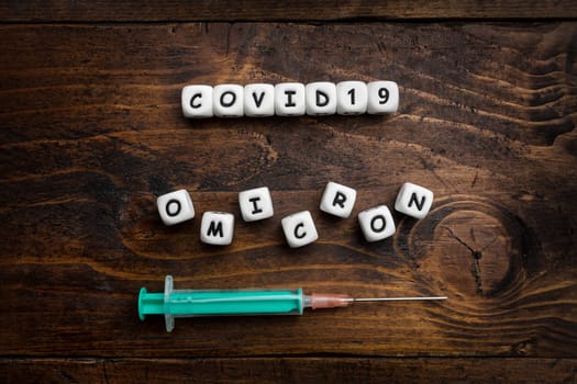Corona virus Covid-19 vaccine text on wooden background