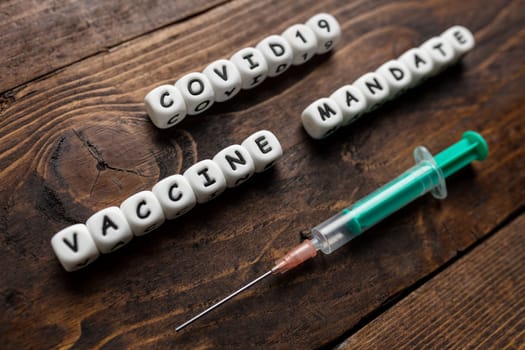 Corona virus Covid-19 vaccine text on wooden background