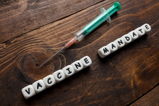 Corona virus Covid-19 vaccine text on wooden background