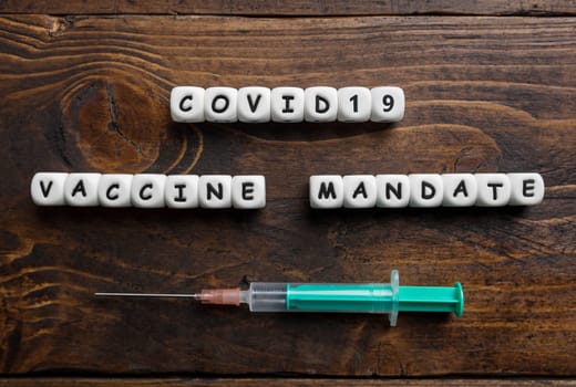 Corona virus Covid-19 vaccine text on wooden background