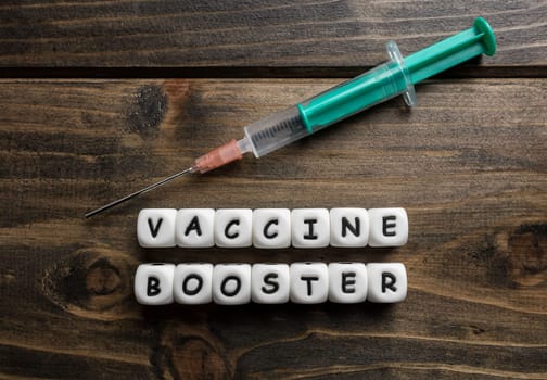 Corona virus Covid-19 vaccine text on wooden background