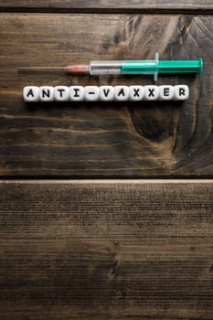 Corona virus Covid-19 vaccine text on wooden background