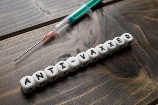 Corona virus Covid-19 vaccine text on wooden background