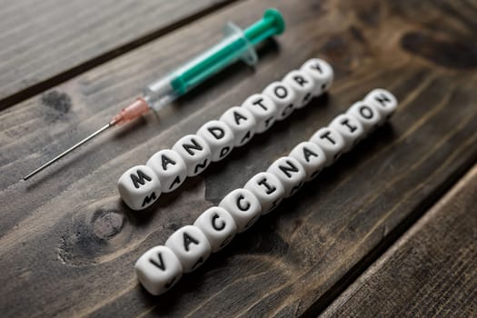 Corona virus Covid-19 vaccine text on wooden background
