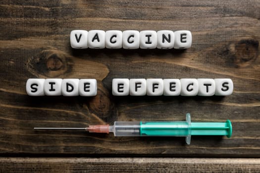 Corona virus Covid-19 vaccine text on wooden background