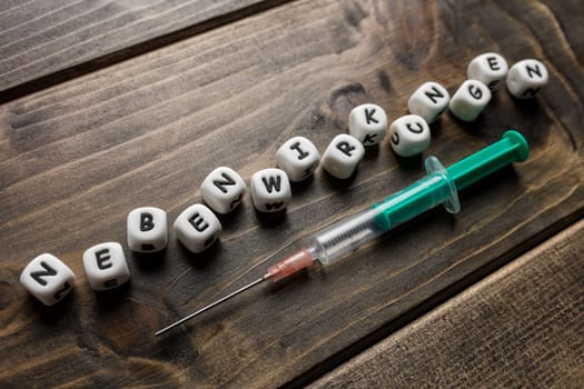 Corona virus Covid-19 vaccine text in German on wooden background