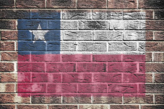 A Chile flag on a brick wall background